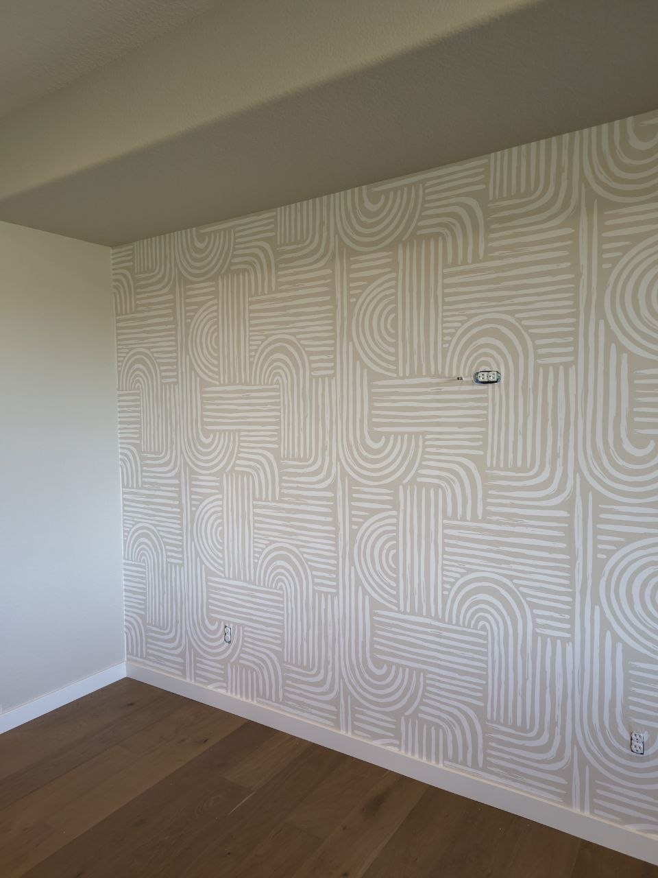Wallpaper installed smoothly across the finished wall